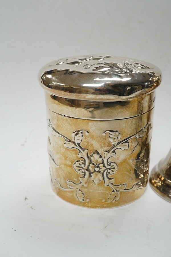 An Edwardian silver 'Reynold's Angels' silver canister, William Comyns, London, 1902, 90mm, together with a silver table perpetual lighter, silver bonbon basket and silver ring box. Condition - poor to fair